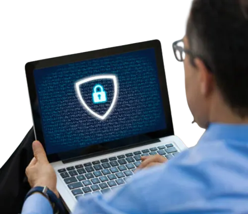 User working on a laptop with a shield and a padlock on screen
